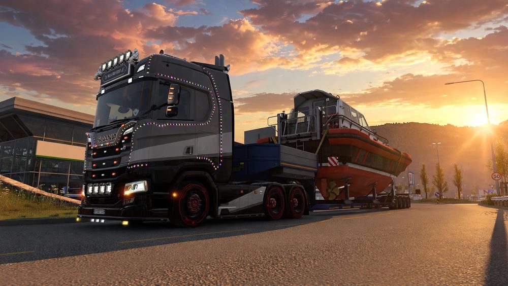 Truck hauling a boat at sunset