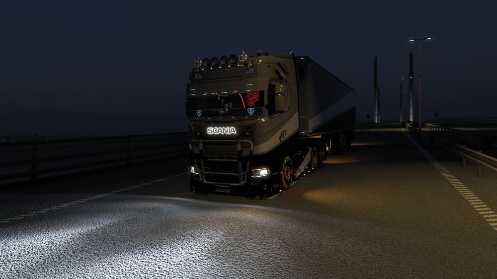 Truck crossing a bridge at night