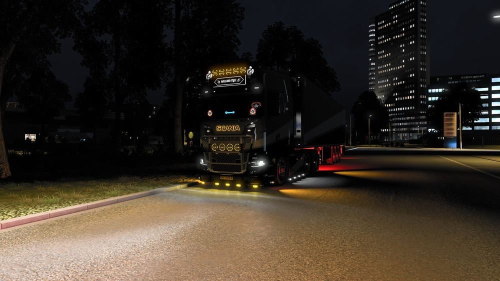 Truck under city lights at night